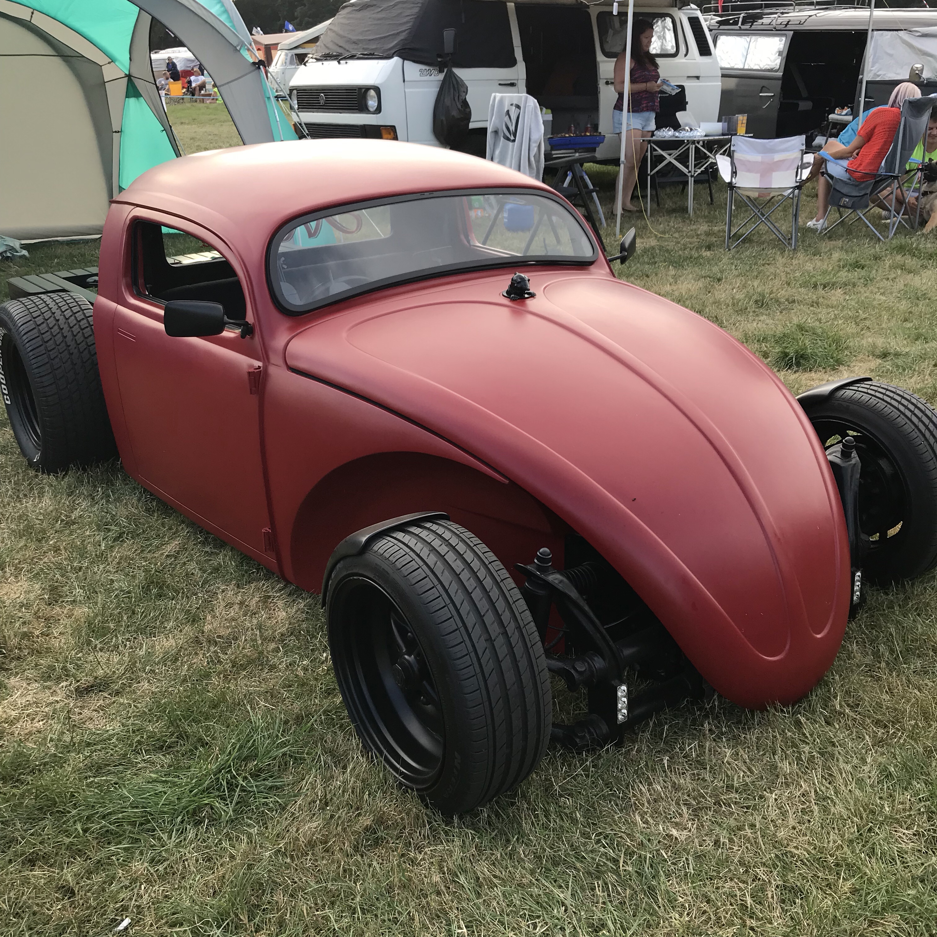 Red volksrod, open wheeled, flat bed with engine showing. VW Hotrod.